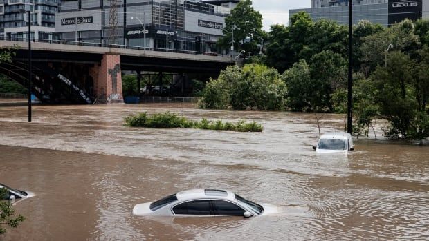 Photo of cars underwater in a flooded roadway