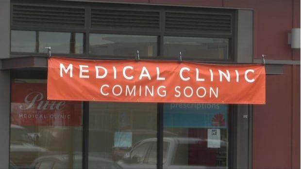 A building with a red sign in front that reads 'Medical Clinic Coming Soon.'