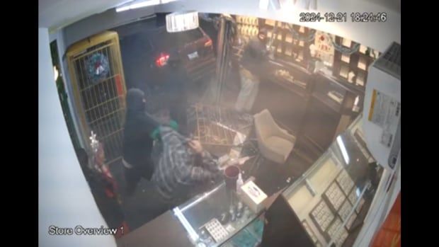 A still image of surveillance footage of a robbery. 