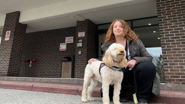 Emily Mclennan, of Kitchener, and her service dog Honey, infront of the Mississauga building where her mom and sister live. Mclennan says she's not felt welcome in the building since she began visiting with Honey.