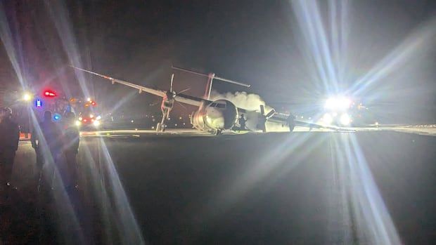 a damaged plane on a runway 