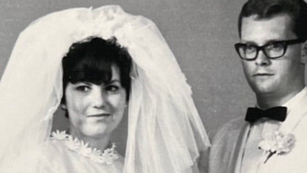 A black-and-white photo of a bride and groom.