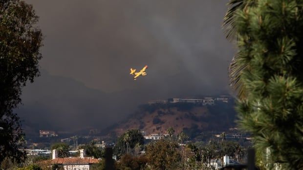 Water bomber flying over fire