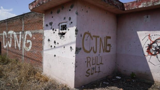 The letters "CJNG" which stands for "Jalisco New Generation Cartel" cover an abandoned home in El Limoncito, Michoacan state, Mexico, Oct. 30, 2021.