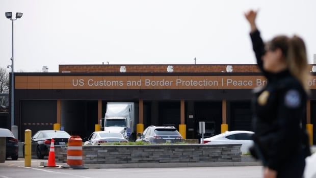 A U.S. Customs and Border Protection officer signals for vehicles at the Peace Bridge Port of Entry in Buffalo, N.Y. on May 23, 2023.