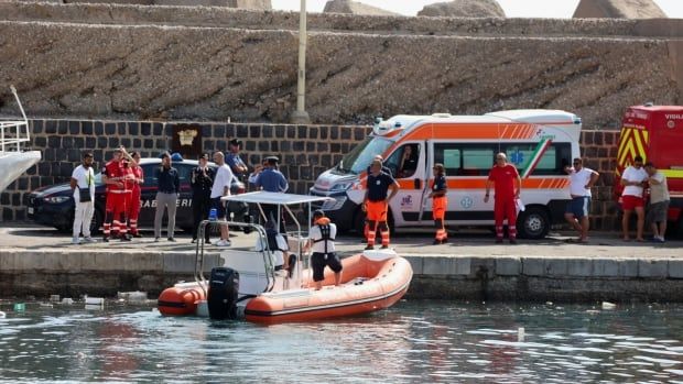 An inflatable craft for water is shown near the pier where several people, including emergency personnel stand. An ambulance is also shown.