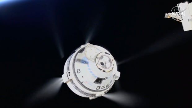 An image of a space capsule, with thruster firing, departing the International Space Station.