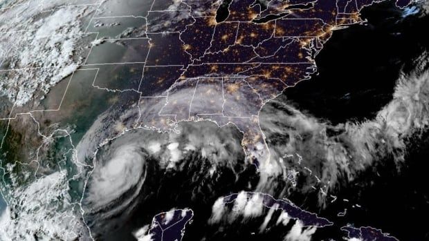 A satellite image of a hurricane swirling in the Gulf of Mexico toward a map of the southern U.S.