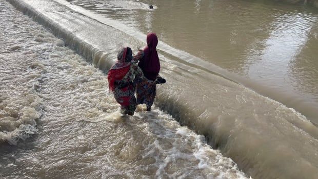 Residents walk as they leave the flooded areas in Maiduguri, northern Borno state, Nigeria in September. 