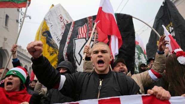 People yell as they march in the street.