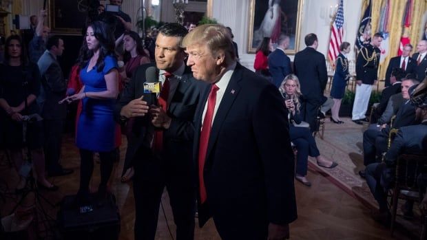 An April 2017 file photo shows then-U.S. president Donald Trump appearing on 'Fox & Friends' with Pete Hegseth. Trump announced Tuesday that he is nominating Hegseth, a Fox News host and Army veteran, to serve as his defence secretary.