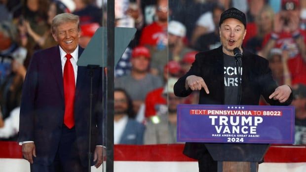 Donald Trump reacts as Elon Musk speaks at a campaign event held in Butler, Pa., last month. Trump went on to win the U.S. election on Nov. 5.