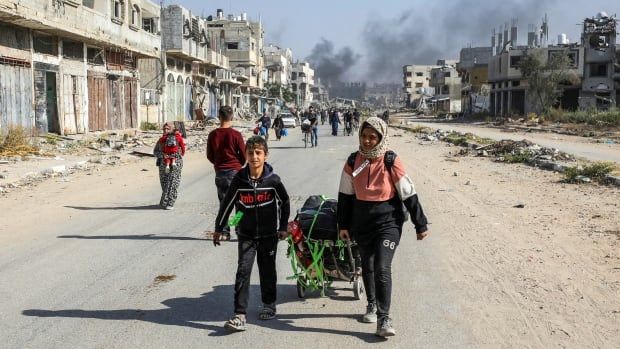 Young children walking with bags in hand.