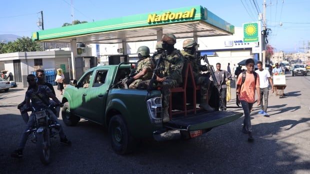 Members of the Haitian Armed Forces are seen on patrol in Port-au-Prince's Poste Marchand suburb.