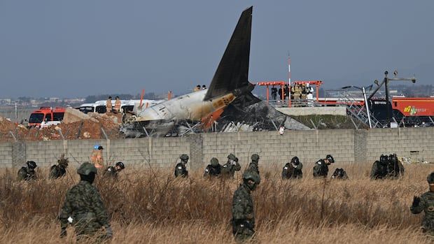 South Korean soldiers search for missing passengers near the wreckage of a Jeju Air Boeing 737-800 series aircraft after the plane crashed