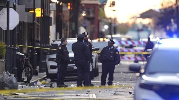 Police gather on the street.