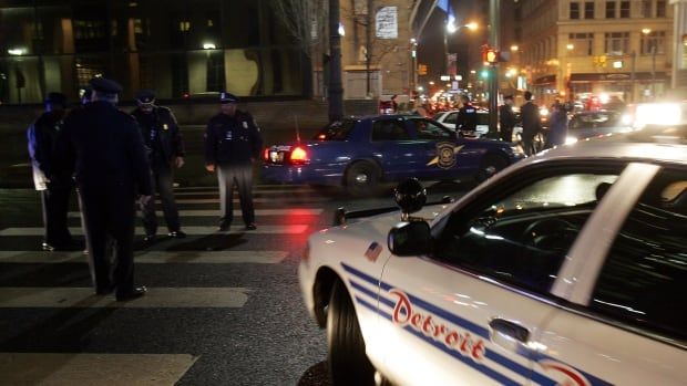 Detroit police restrict the intersection of Woodward Avenue and Congress in downtown Detroit after a shooting left one dead and one wounded outside a bar around 1:30 am February 4, 2006. The shooting occurred steps away from Motown Winter Blast, a four-day festival held in conjunction with Super Bowl XL. Winter Blast had concluded at 1 am but hundreds of people were still on the streets celebrating the Feb. 5 Super Bowl XL to be held in downtown Detroit. REUTERS/Rebecca Cook