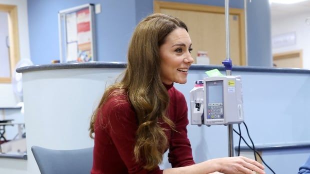 Three people talking in a hospital