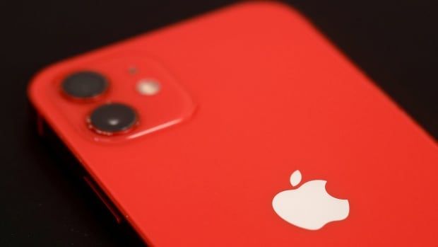 A photograph of a red iPhone 12.