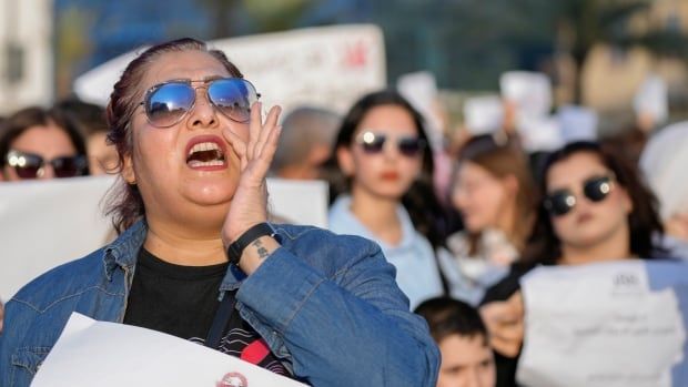 A woman chants at a protest.