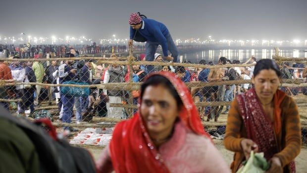 A man climbs a fence in Allahabad, India.