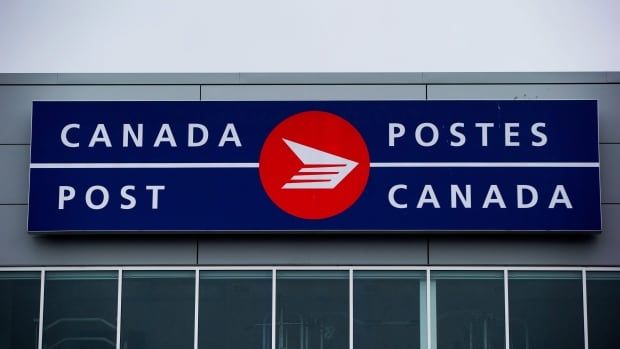 A red and blue sign on an office building reads "Canada Post."