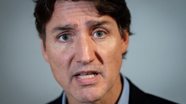 Prime Minister Justin Trudeau speaks to media in Vancouver. Trudeau has said he will carry on as prime minister and take the Liberals into the next federal election no matter what happens.