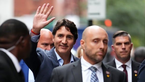 Prime Minister Justin Trudeau, flanked by entourage and security