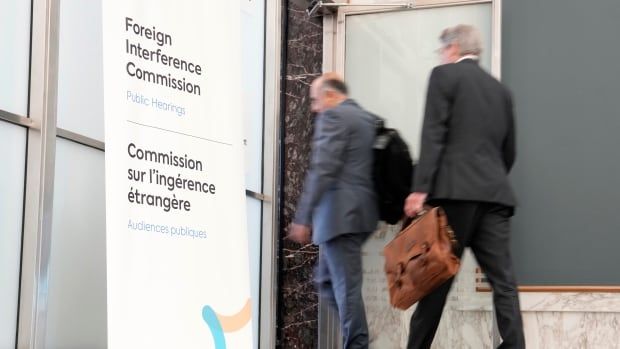 Lawyers enter the hearing room as the Public Inquiry into Foreign Election Interference resumes in Ottawa, Monday, Sept. 16, 2024.