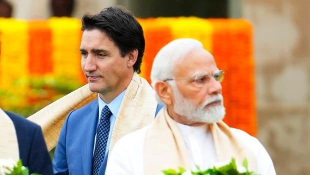 Prime Minister Justin Trudeau, left, walks past India's Prime Minister Narendra Modi as they take part in a wreath-laying ceremony at Raj Ghat, Mahatma Gandhi's cremation site, during the G20 Summit in New Delhi, Sunday, Sept. 10, 2023.