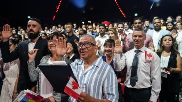 Some of the nearly 400 new Canadians from 65 countries who took the oath of citizenship at a ceremony in Toronto on Friday, July 19, 2024.