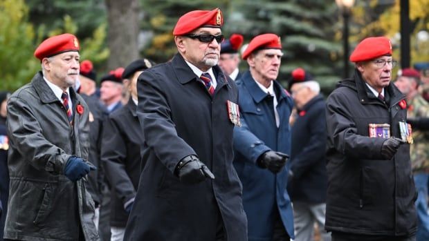 Men march in the street.