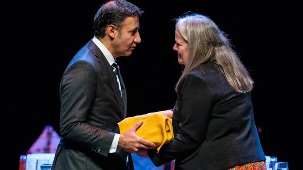 Minister of Justice and Attorney General of Canada Arif Virani, left, receives a report by Independent Special Interlocutor for Missing Children and Unmarked Graves and Burial Sites associated with Indian Residential Schools during a national gathering in Gatineau, Que., Tuesday, Oct. 29, 2024. 