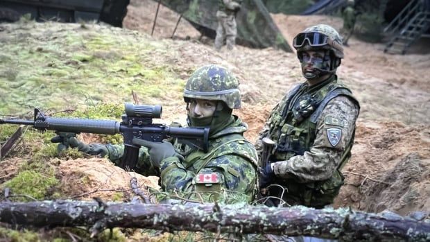 Cpl. Guillaume Lavoie and Cpl. Matthew Bowler from Quebec show a defensive position in a trench during Resolute Warrior military exercises in Latvia. Credit * 