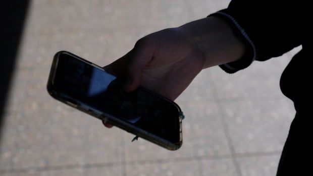 A teenage girl uses her phone in Sydney, Friday, Nov. 8, 2024. 