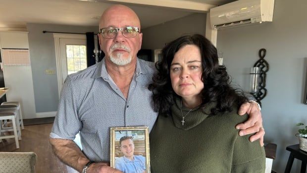 Carl Burke and Barbie Lavers hold up a photo of Harry Burke.