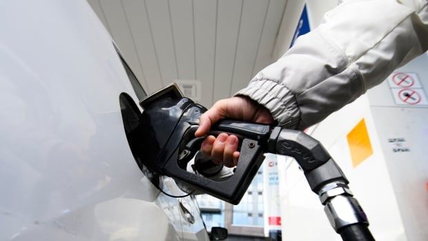 A woman gasses up at a gas station in Mississauga, Ont.,  Tuesday, February 13, 2024. Ontario Premier Doug Ford says his government will introduce legislation that would put any future provincial carbon pricing program to a referendum. THE CANADIAN PRESS/Christopher Katsarov