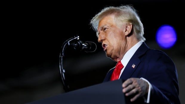 A person speaks at a lectern.