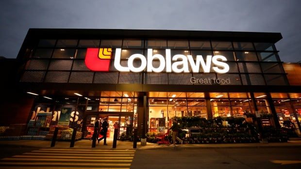 A loblaws  store pictured from the parking lot in the evening