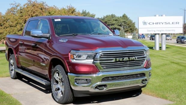 A pickup truck is seen parked outside a dealership.