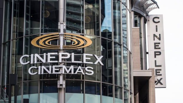 The outside of a building is shown, with the big letters saying "Cineplex" on the outside. The building has a lot of glass windows. 