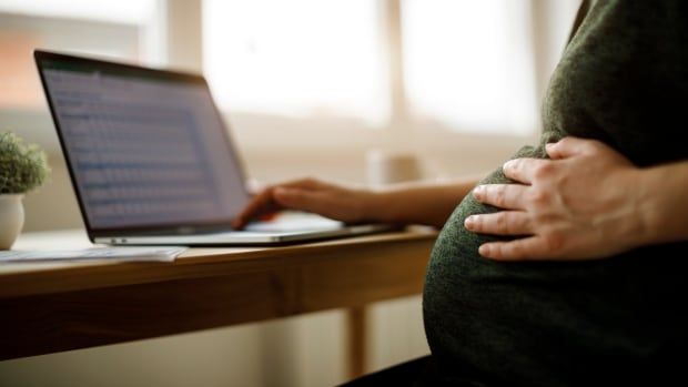 Pregnant woman using laptop