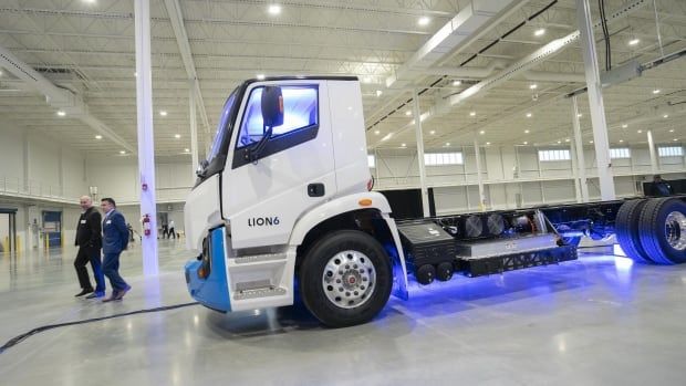 An electric truck inside a large warehouse. 