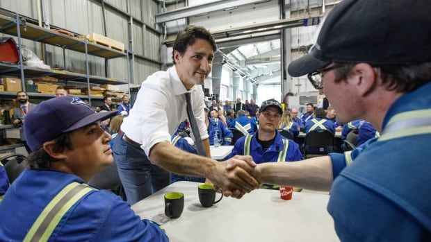 Prime Minister Justin Trudeau speaks with workers at the Trans Mountain Terminal in Edmonton on Friday, July 12, 2019.