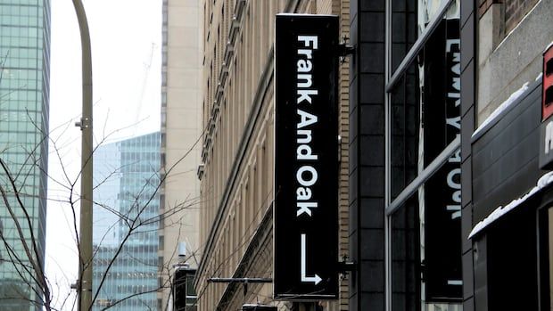 The sign of a Frank And Oak store is shown on a montreal downtown street