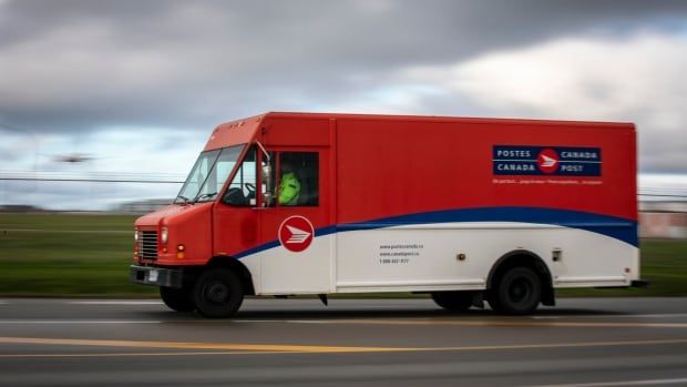 A Canada Post truck on a highway.