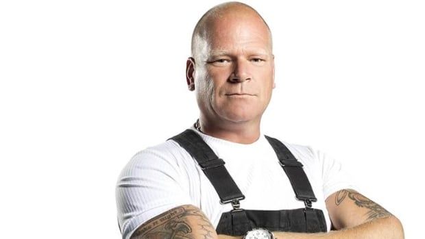 Mike Holmes posing with his arms crossed.