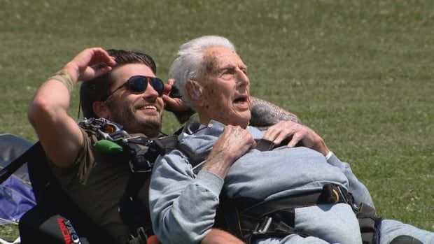 Two men having touched down from a skydiving jump