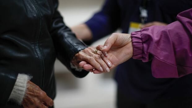 Alzheimer's patients hands are seen at the Village Landais Alzheimer site in Dax, France, in 2020. 