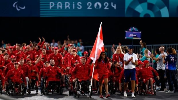 A group of Canadian athletes marches together.